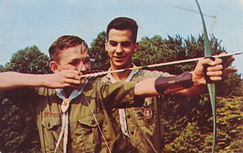 Featured is a postcard image of a boy scout receiving instruction in archery at a NH Boy Scout Camp. The original postcard (in less than optimal condition) is for sale in The unltd.com Store.